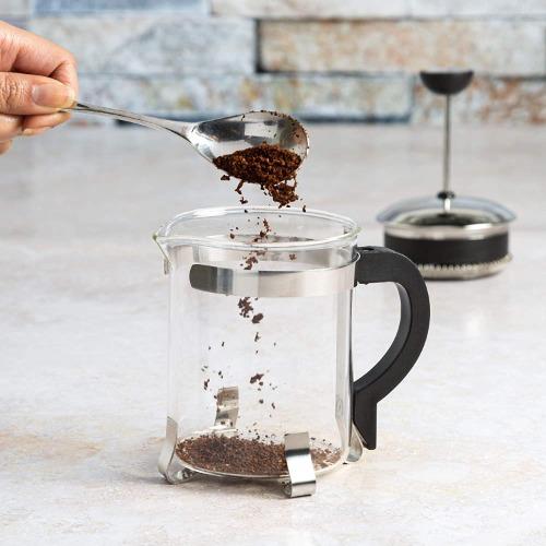 Classic Coffee Press coffee being added on counter