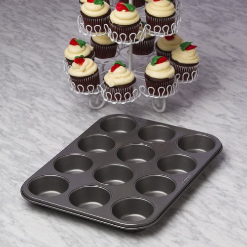 Muffin Pan 12 Cup next to cupcakes on counter
