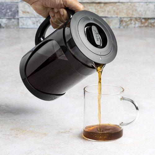 Burke Cold Brew Coffee Maker being poured into coffee mug on counter