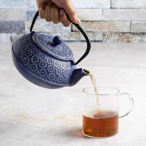Blue Cast Iron Teapot Pouring Tea